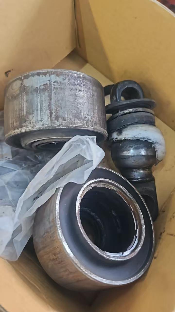 Defective truck torque rod bushings showing molding blisters and rubber separation