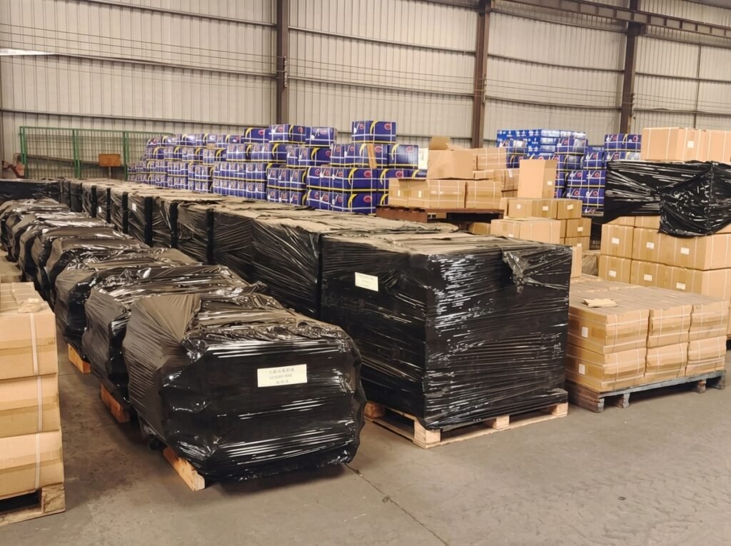 Storage warehouse with wrapped pallets of heavy-duty truck spare parts ready for global shipping