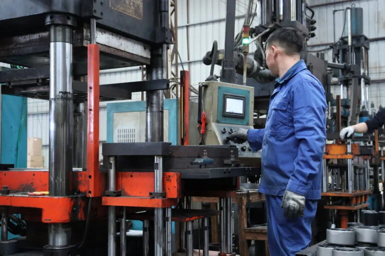 Skilled worker operating an industrial hydraulic press machine in a truck spare parts factory